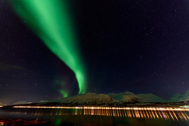 Northern lights over the Solenagen fjord in front of the Lyngenfjord Alps