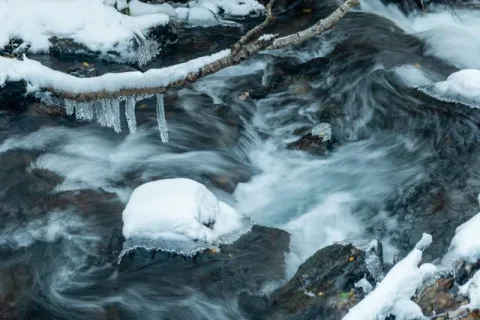 Icicles over small creek in Andorra