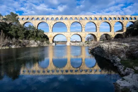 The Pont du Gard reflected in the Gardon